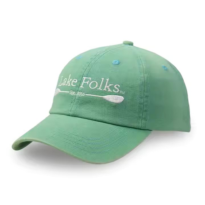 Washed green baseball cap with white embroidered front logo and curved brim
