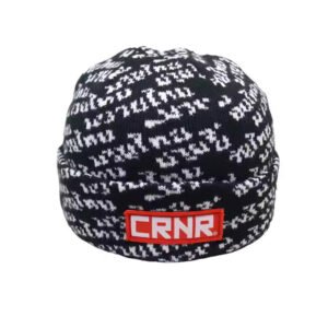 Black and white small beanie with CRNR logo patch and jacquard knit design.