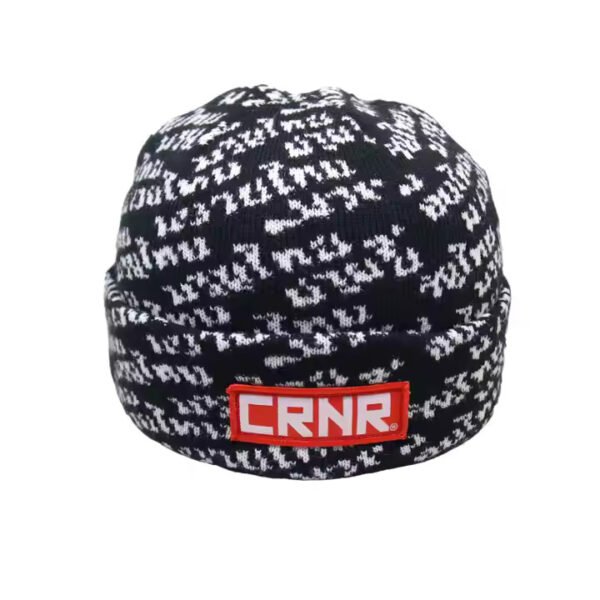 Black and white small beanie with CRNR logo patch and jacquard knit design.