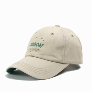 Beige cotton dad hat with green embroidery and curved brim, breathable and customizable.
