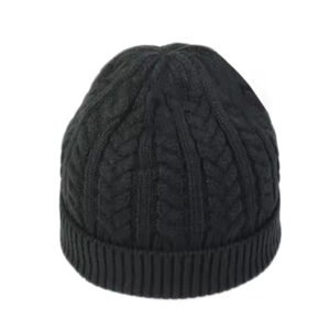 Black cable-knit short beanie made from soft acrylic yarn.