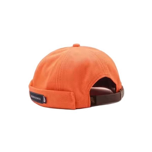 Orange snapback dad hat without brim, featuring a custom woven label.