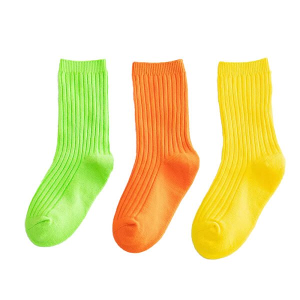 Colorful personalized tube socks for kids in green, orange, and yellow cotton.